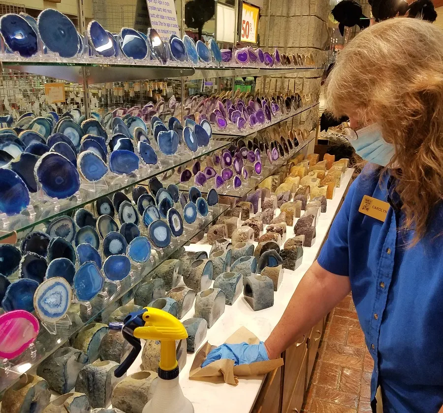 Sanitizing and disinfecting surfaces inside the visitors center gift shop at Fantastic Caverns